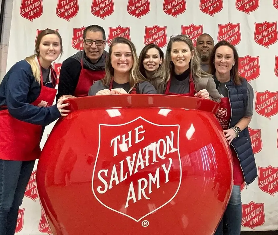 Teams from the SPIRE Home Office smiling for portrait at the salvation army
