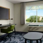 A hotel room lounge with a sofa and window view at a Broomfield, CO hotel