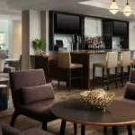 A hotel lounge with a bar and plush seating at a Broomfield, CO hotel