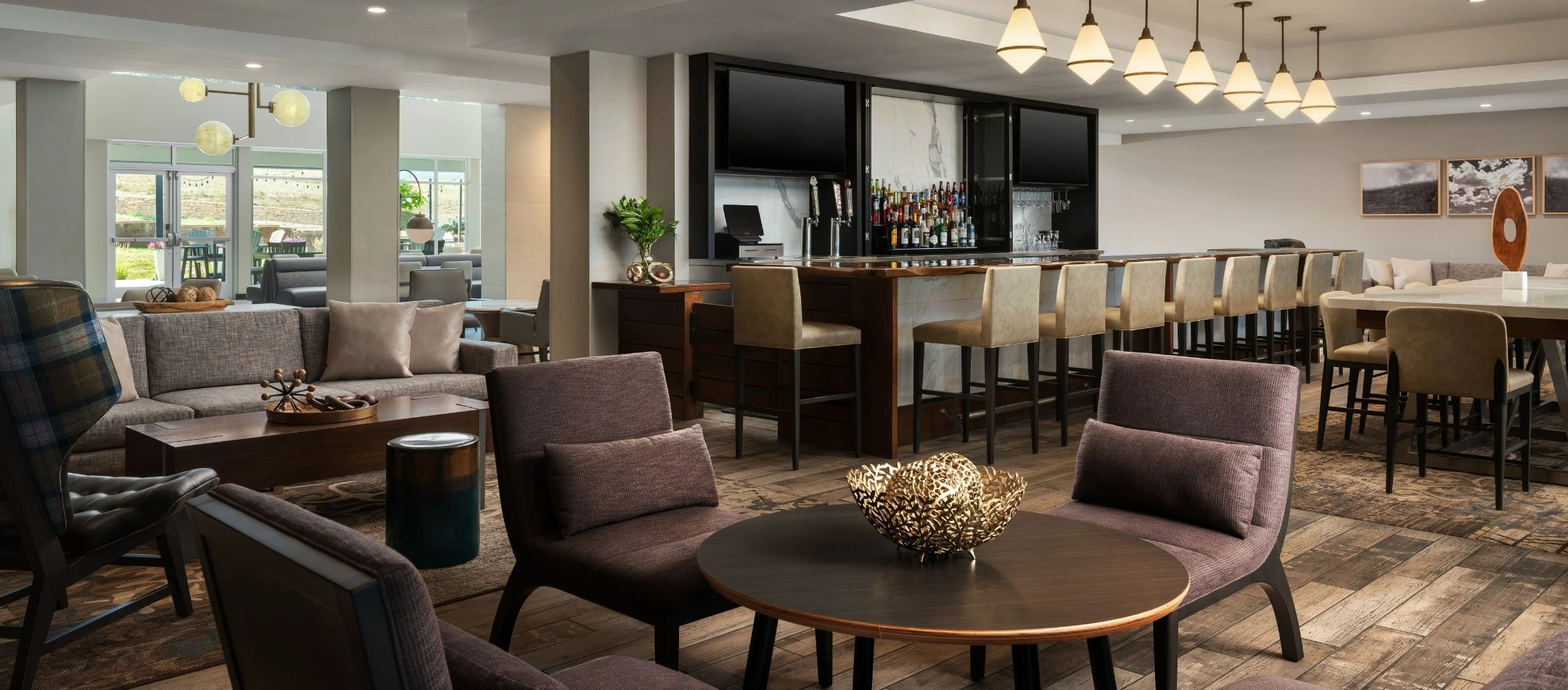 A hotel lounge with a bar and plush seating at a Broomfield, CO hotel