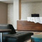 A front desk with marble counter at a Broomfield, CO hotel
