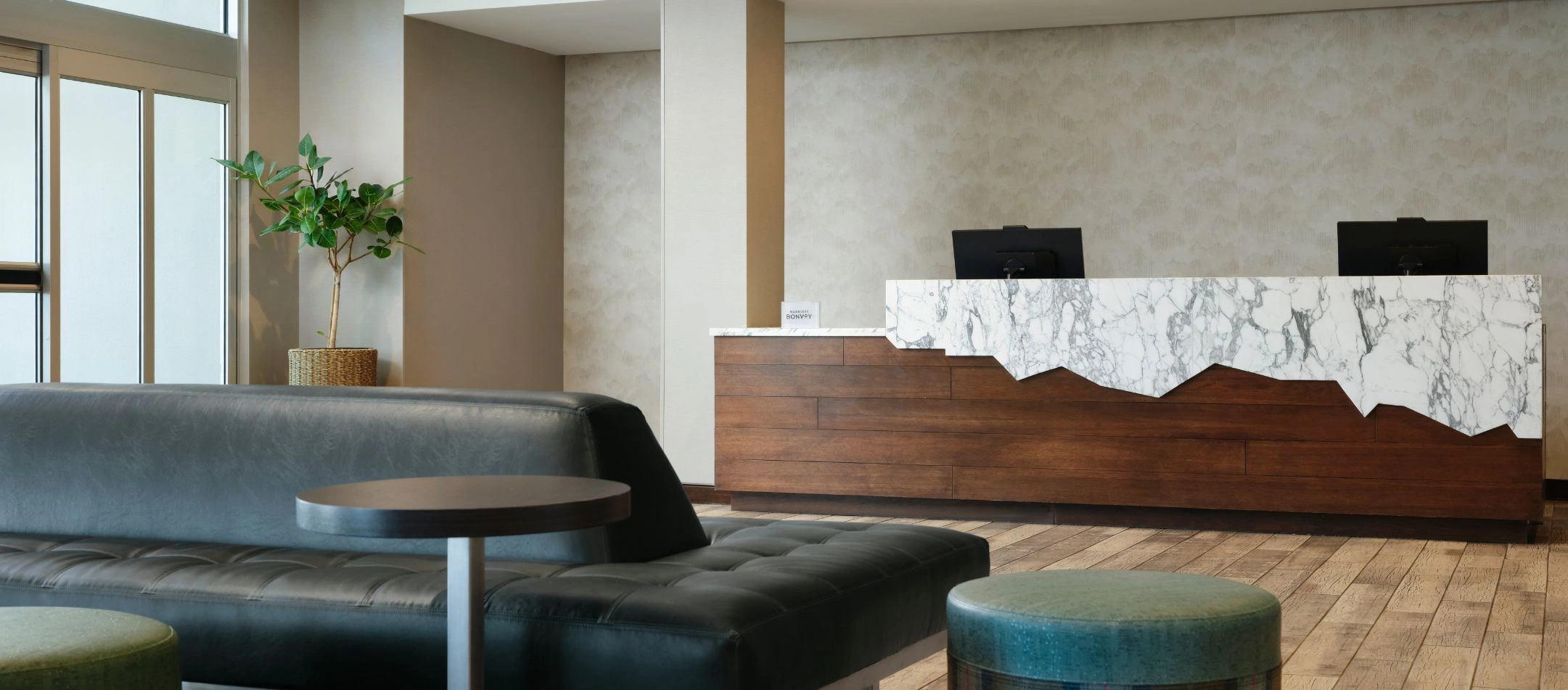 A front desk with marble counter at a Broomfield, CO hotel