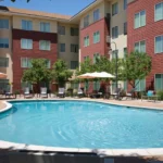 An outdoor pool surrounded by lounge chairs at a Broomfield, CO hotel