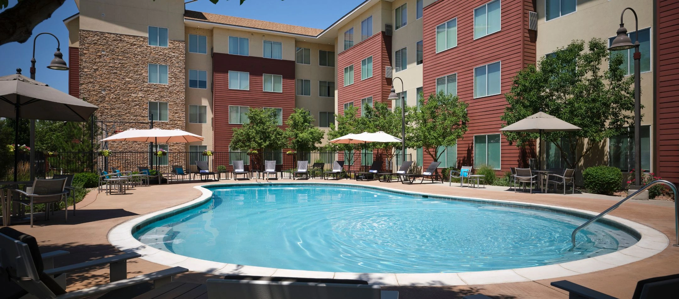 An outdoor pool surrounded by lounge chairs at a Broomfield, CO hotel