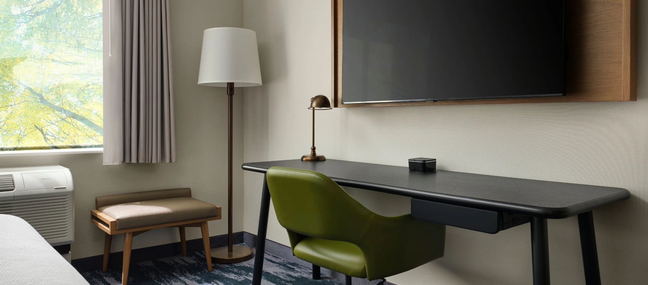 A desk and wall-mounted TV at a Broomfield, CO hotel