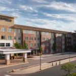 An exterior view of a hotel with a covered entrance at a Broomfield, CO hotel