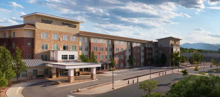 An exterior view of a hotel with a covered entrance at a Broomfield, CO hotel