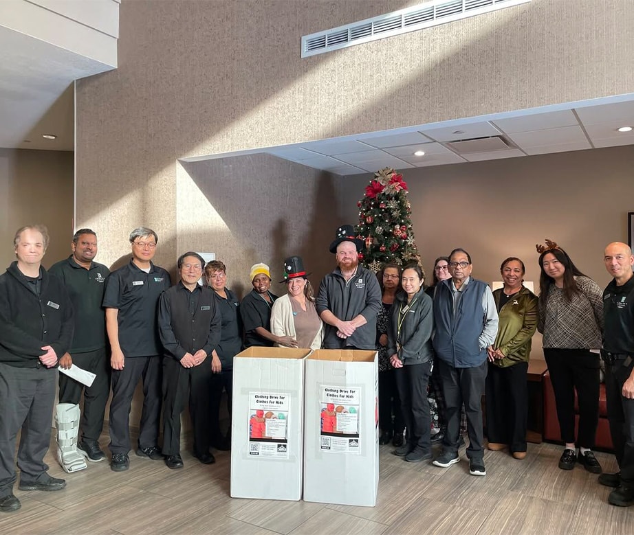 embassy suites team smiling in front of toy drive