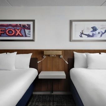 a guest room with two queen beds at hilton detroit
