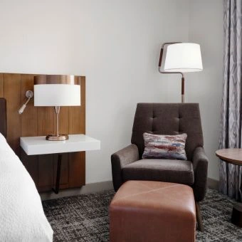 the living room in a guest room at hilton detroit