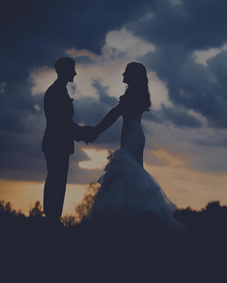 couple poses at sunset on their wedding day