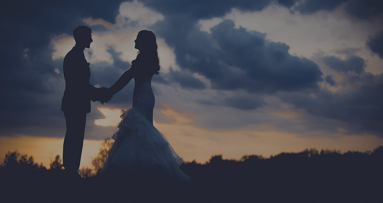 couple poses at sunset on their wedding day