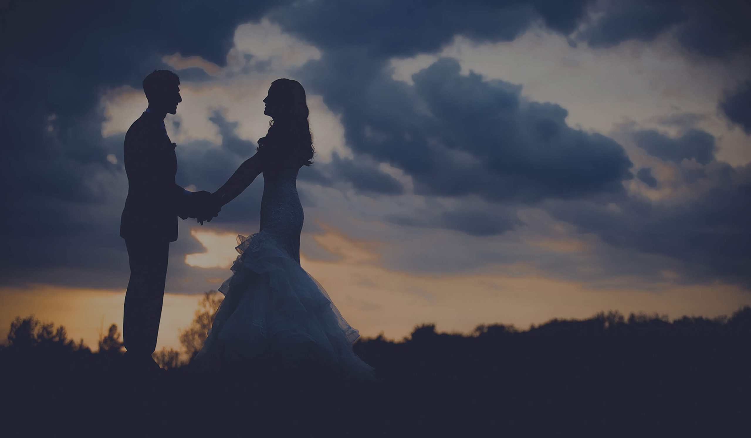 couple poses at sunset on their wedding day