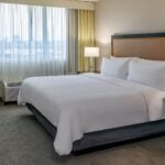 A guest bed at Holiday Inn & Suites Boston-Peabody
